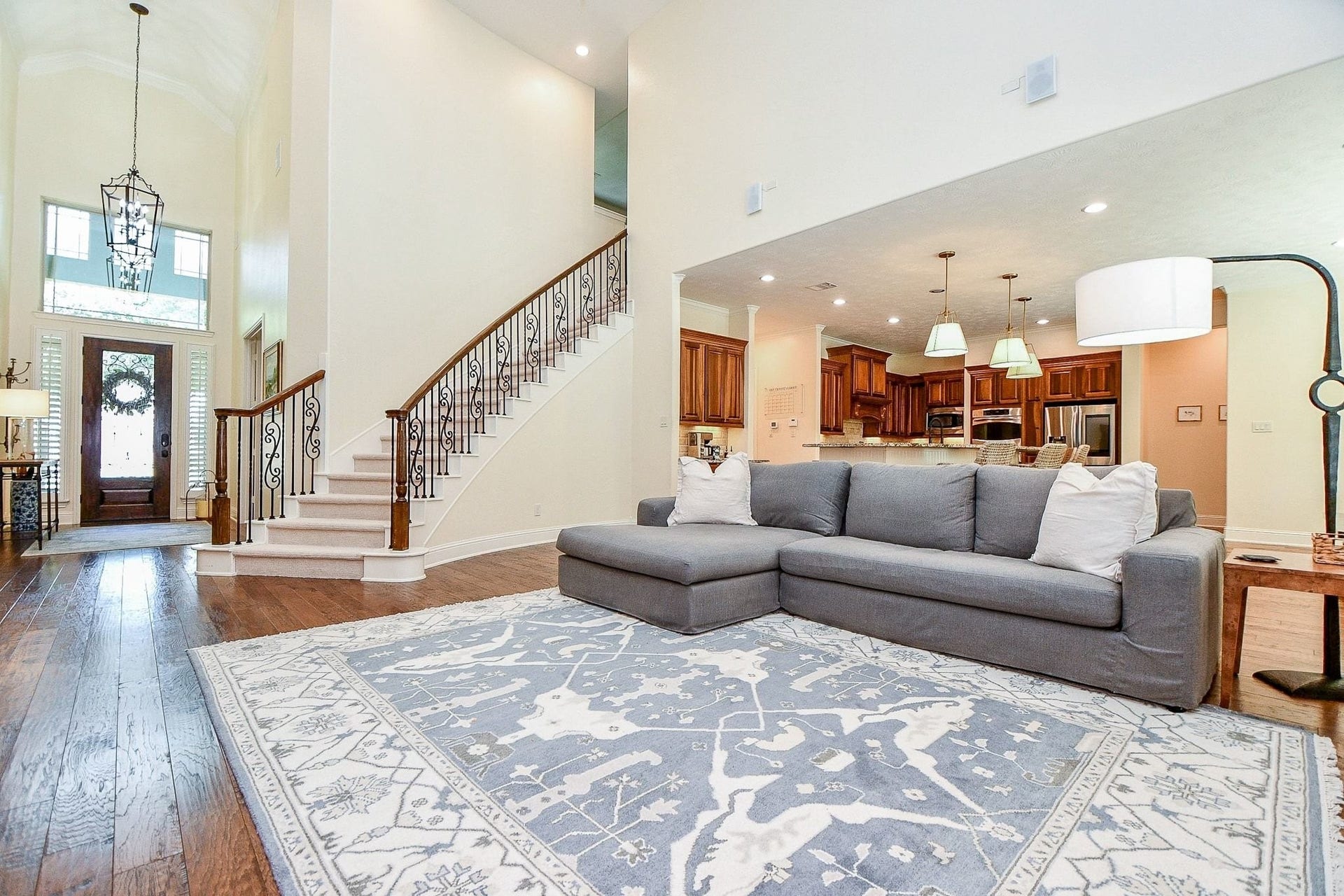 11410 Sardinia Drive, Richmond, TX 77406 The living room is truly a showstopper, featuring soaring two-story ceilings, a stunning curved wrought-iron staircase, and an expansive layout with plenty of space for oversized furniture pieces.