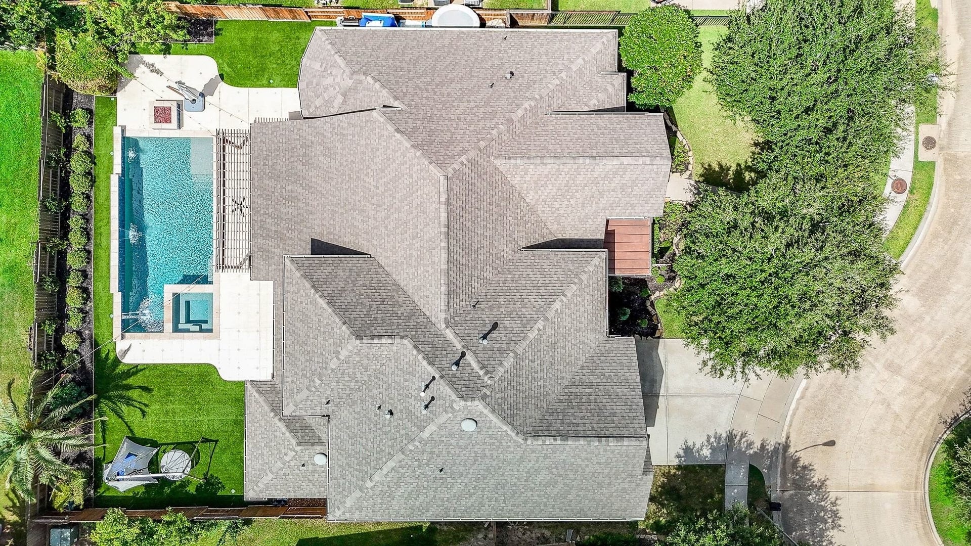 11410 Sardinia Drive, Richmond, TX 77406 Even from this vantage point, the meticulous care and attention to detail are evident. Beautifully manicured landscaping surrounds the stunning pool, hot tub, and firepit, while the newer roof, just two years old, adds even more peace of mind.