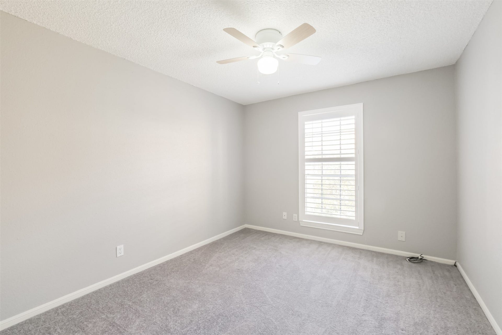 3100 Jeanetta Street, #1204, Houston, TX 77063 Comfortable secondary bedroom featuring carpet and a ceiling fan!
