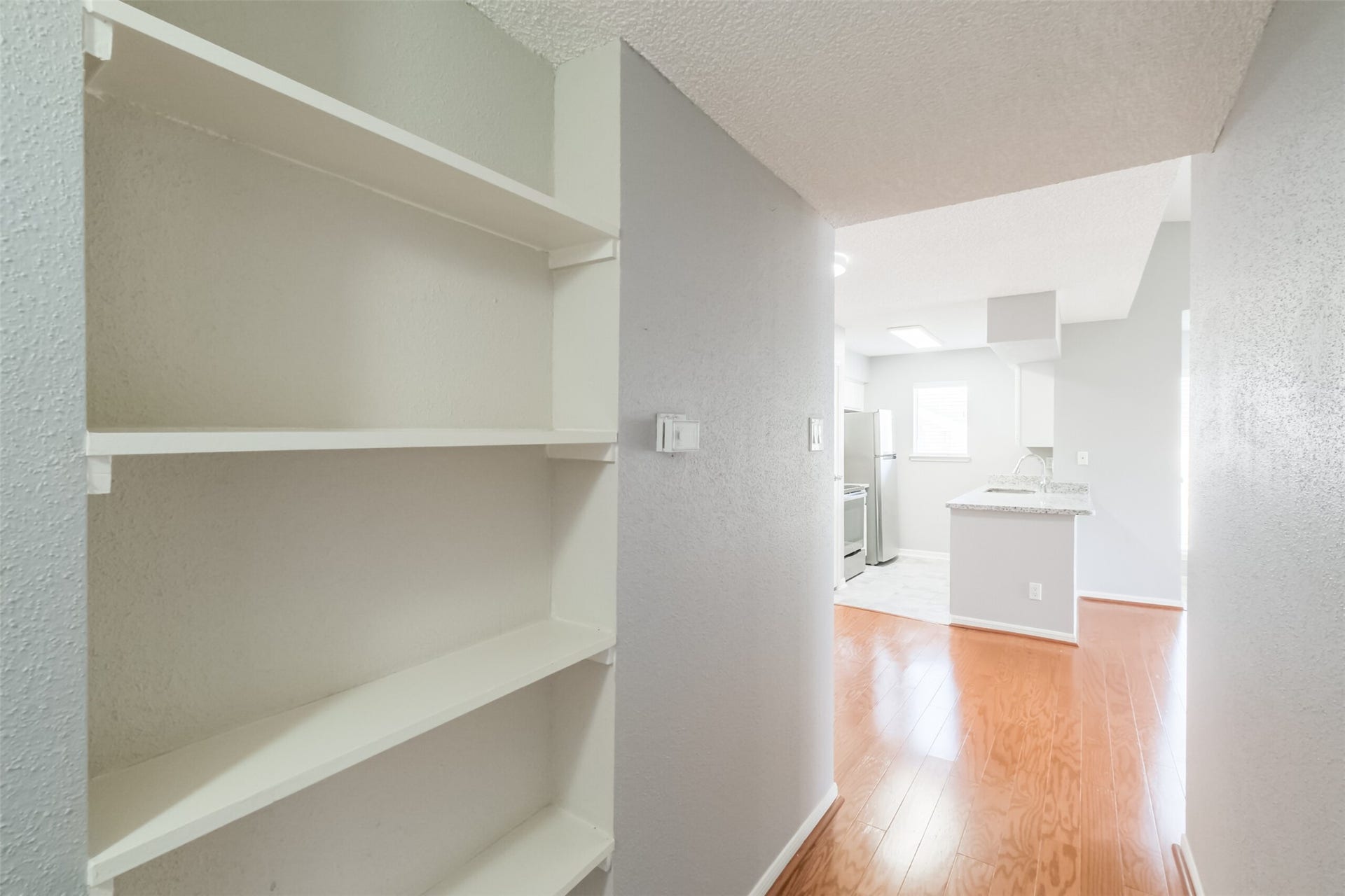 3100 Jeanetta Street, #1204, Houston, TX 77063 Hallway with extra shelving, perfect for books, decor, or storage!