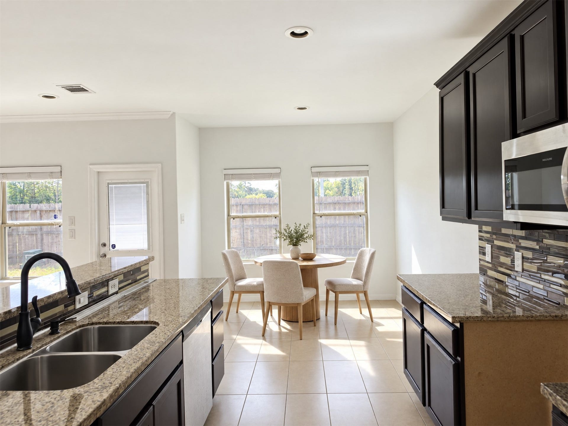 7202 Foxmoor Lake Court, Humble, TX 77338 Staged breakfast nook shows a cozy spot beside the kitchen.