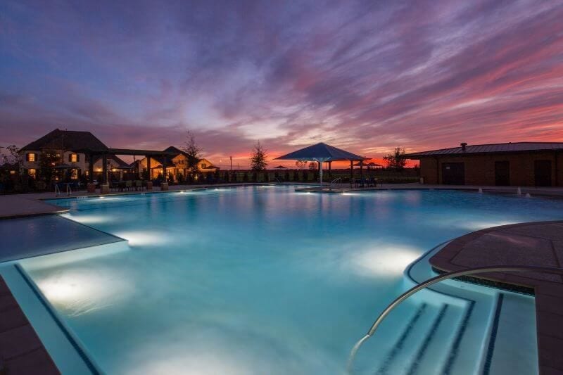Enjoy resort-style living in Elyson with a beautiful community swimming pool and inviting evening atmosphere.