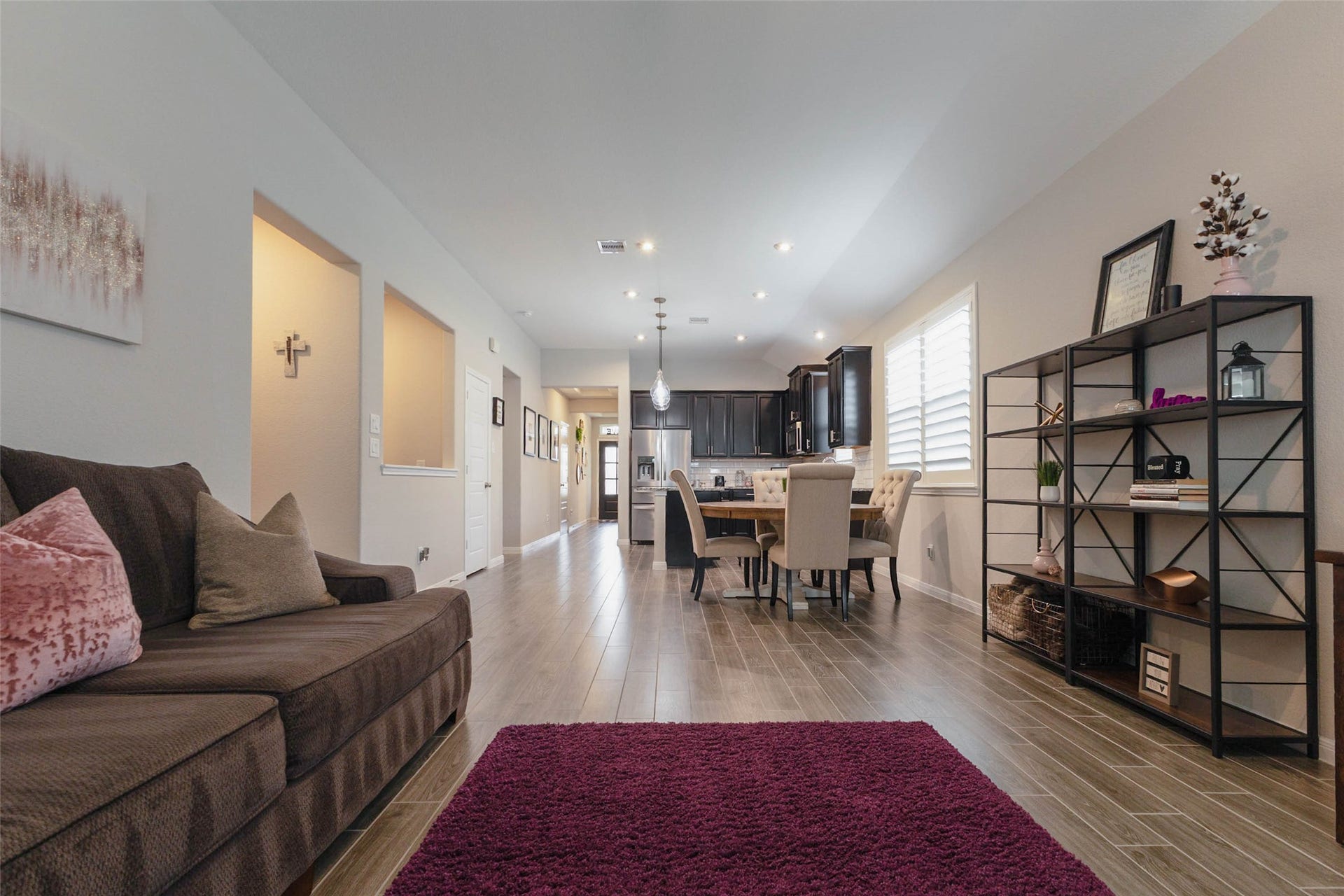 Additional living room view highlighting the open layout, natural light, and seamless connection to the kitchen and dining areas.