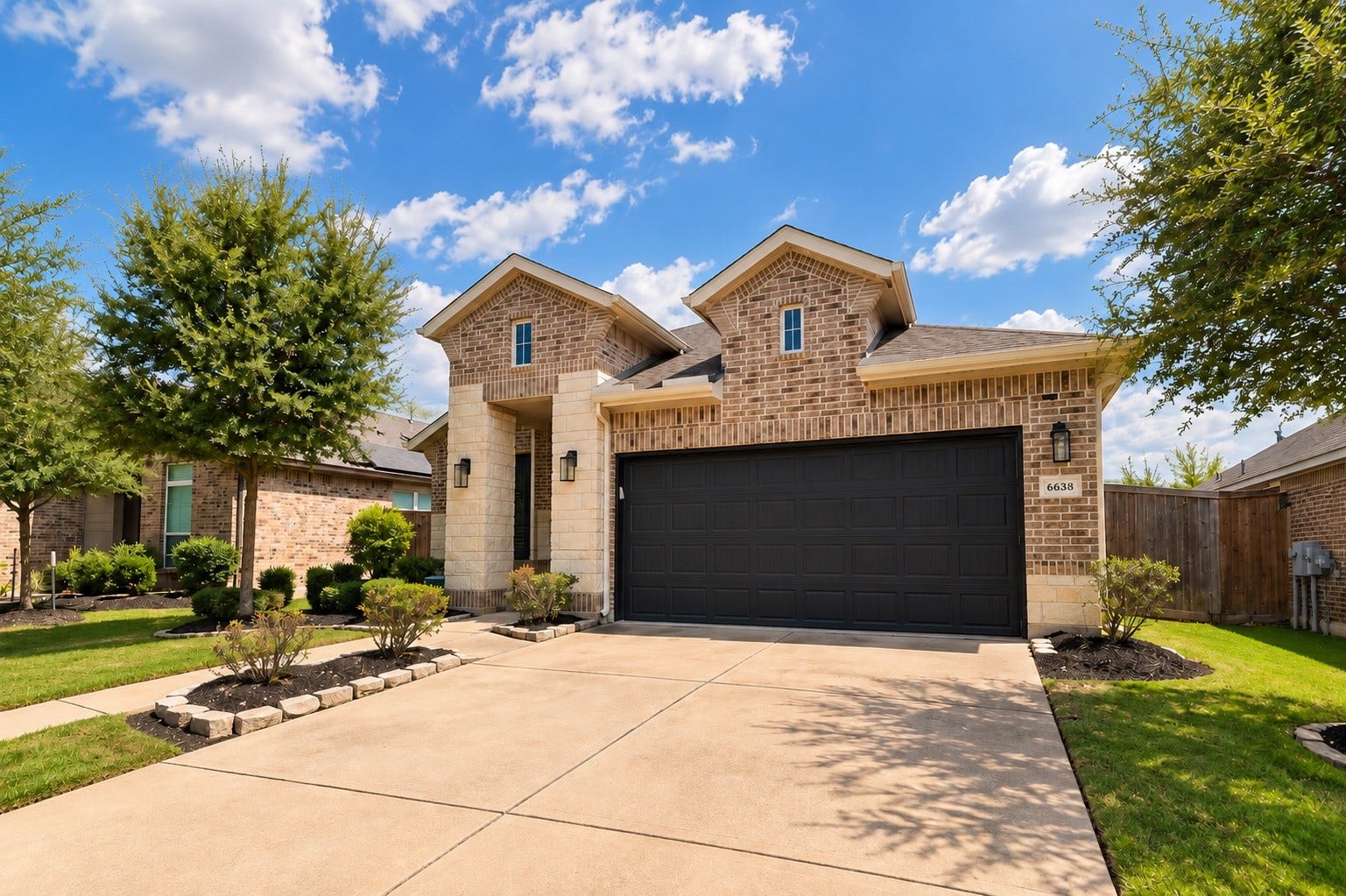 Additional front exterior view showcasing the spacious driveway, manicured lawn, and charming curb appeal.