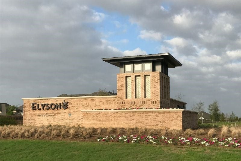 Welcome to Elyson! Beautiful community entrance showcasing the neighborhood's distinctive signage and landscaping.