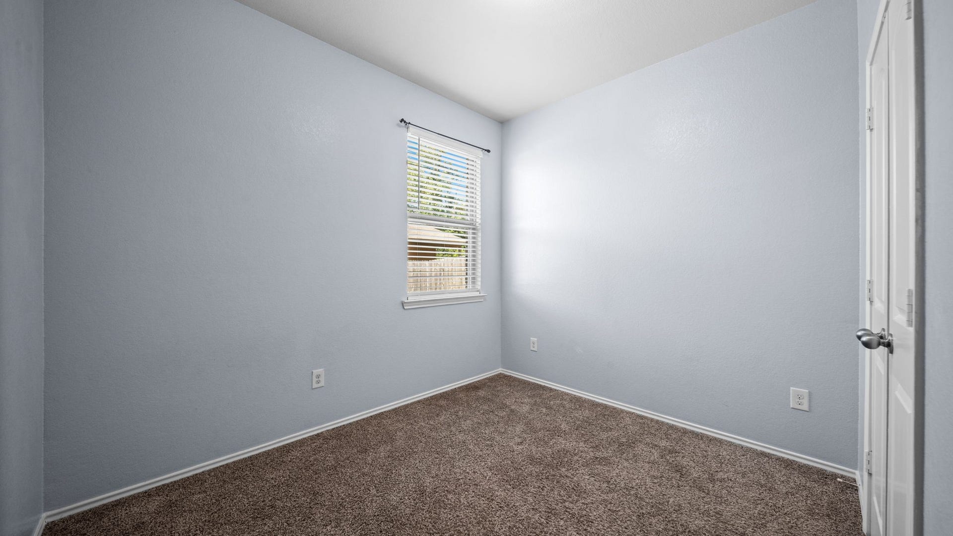 11502 Castle Nugent Court, Conroe, TX 77304 Comfortable secondary bedroom with soft carpeting and window blinds, ready to make your own.