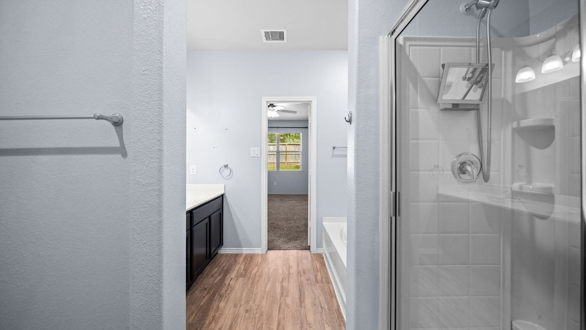 11502 Castle Nugent Court, Conroe, TX 77304 Enjoy the convenience of a separate walk-in shower in the primary bathroom.