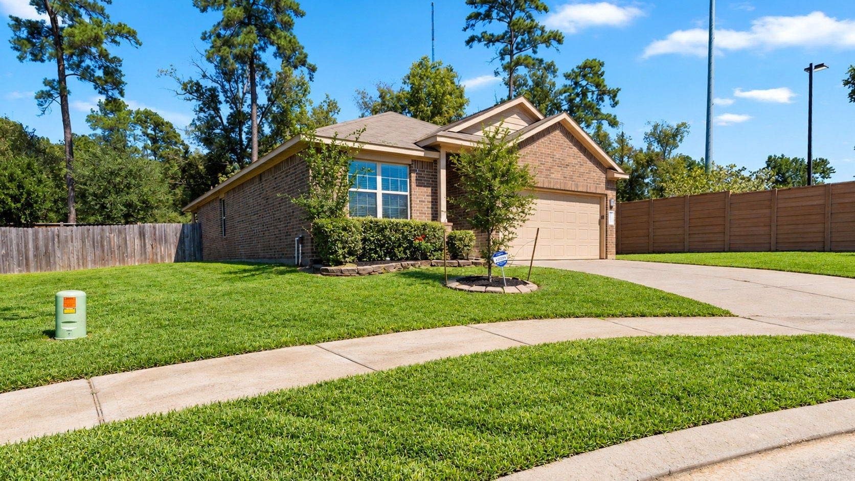 11502 Castle Nugent Court, Conroe, TX 77304 Beautiful front lawn and mature landscaping add to the home's welcoming curb appeal.