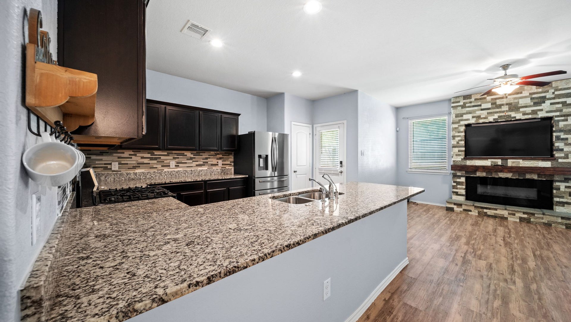 11502 Castle Nugent Court, Conroe, TX 77304 Perfect for everyday living and entertaining! Open-concept kitchen with breakfast bar flows seamlessly into the inviting living room.