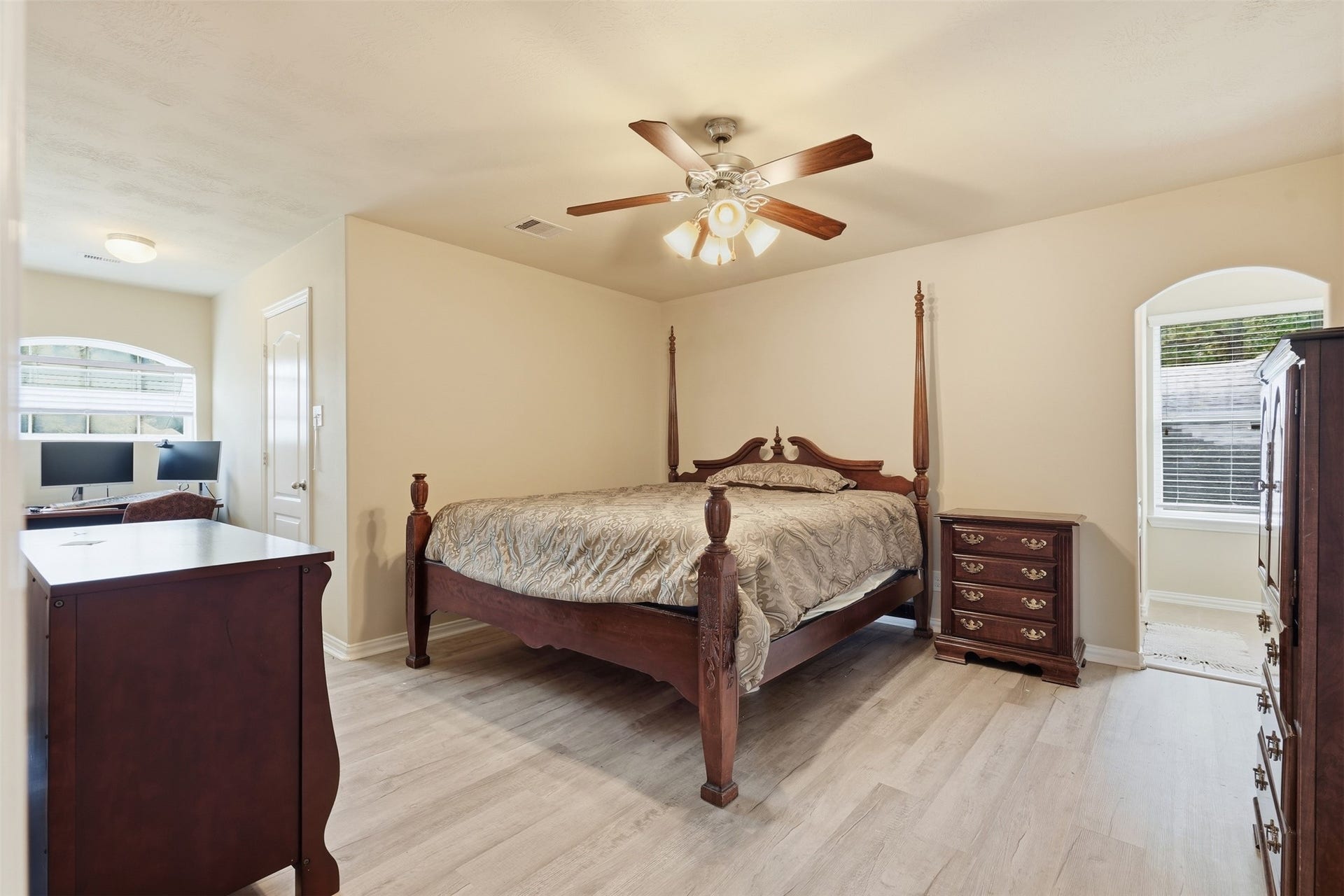 An upstairs bedroom with a bonus: a built-in office nook beneath the arched front window. Work from home without giving up the guest room.