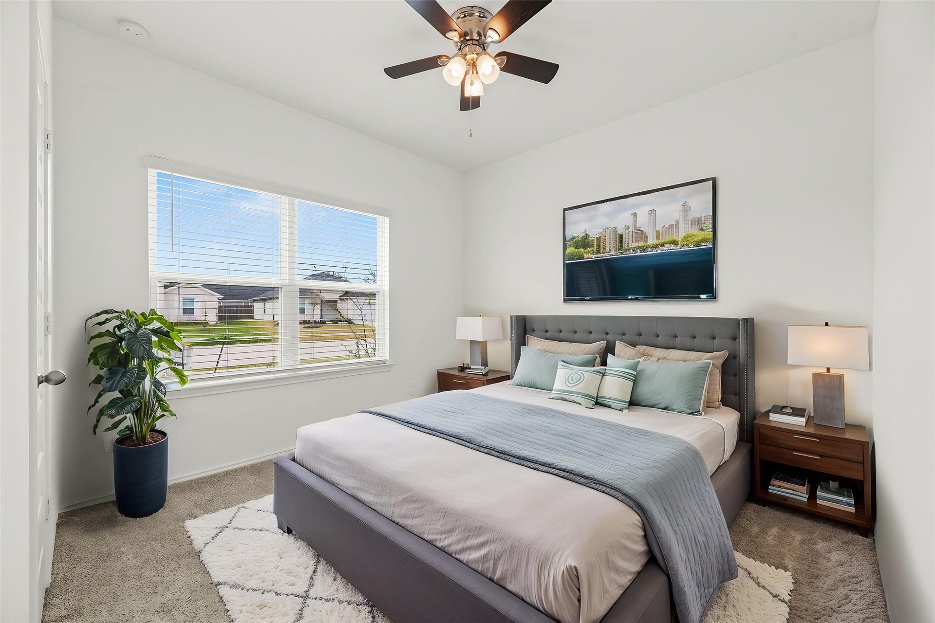 2815 Magnolia Blossom Lane, Rosenberg, TX 77469 One of two bedrooms situated on the first floor, this space is equipped with a cooling ceiling fan. This versatile room is ideal for a guest suite or a private home office, providing a flexible layout to suit your lifestyle. Virtually staged.