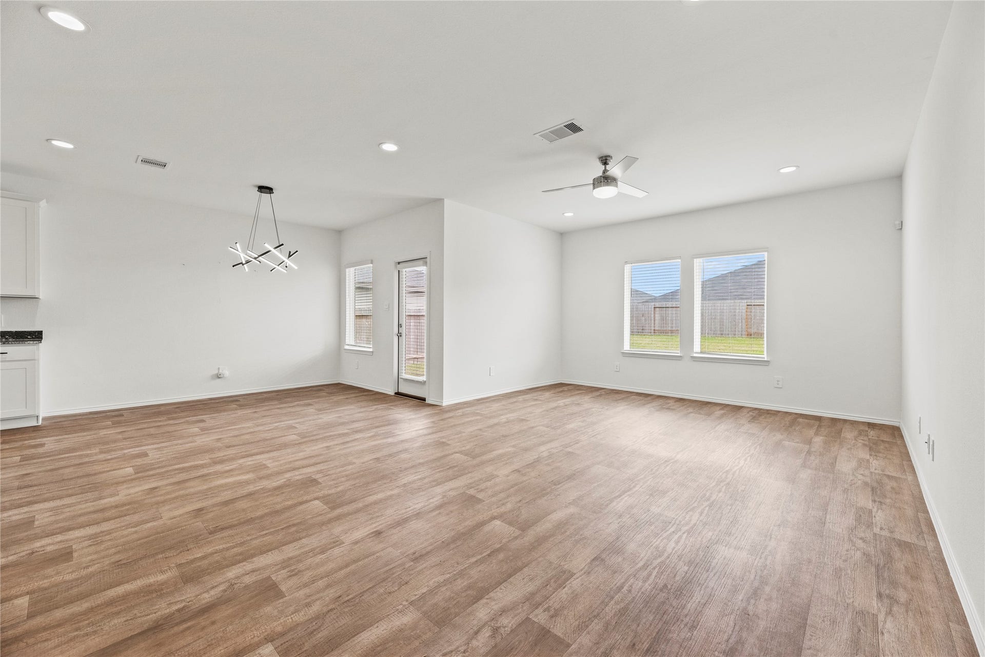 2815 Magnolia Blossom Lane, Rosenberg, TX 77469 The open-concept design thoughtfully connects the living, dining, and kitchen areas, creating a seamless and versatile space.