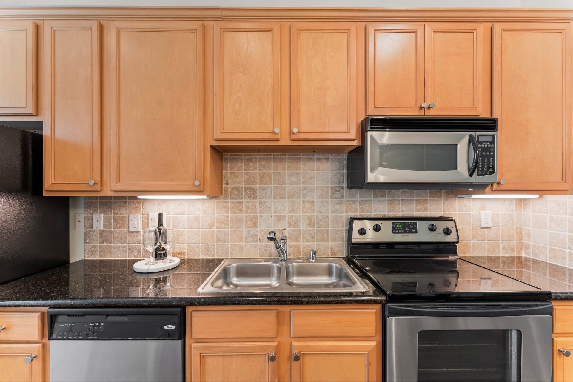 Electric stove with plenty of granite counter space.