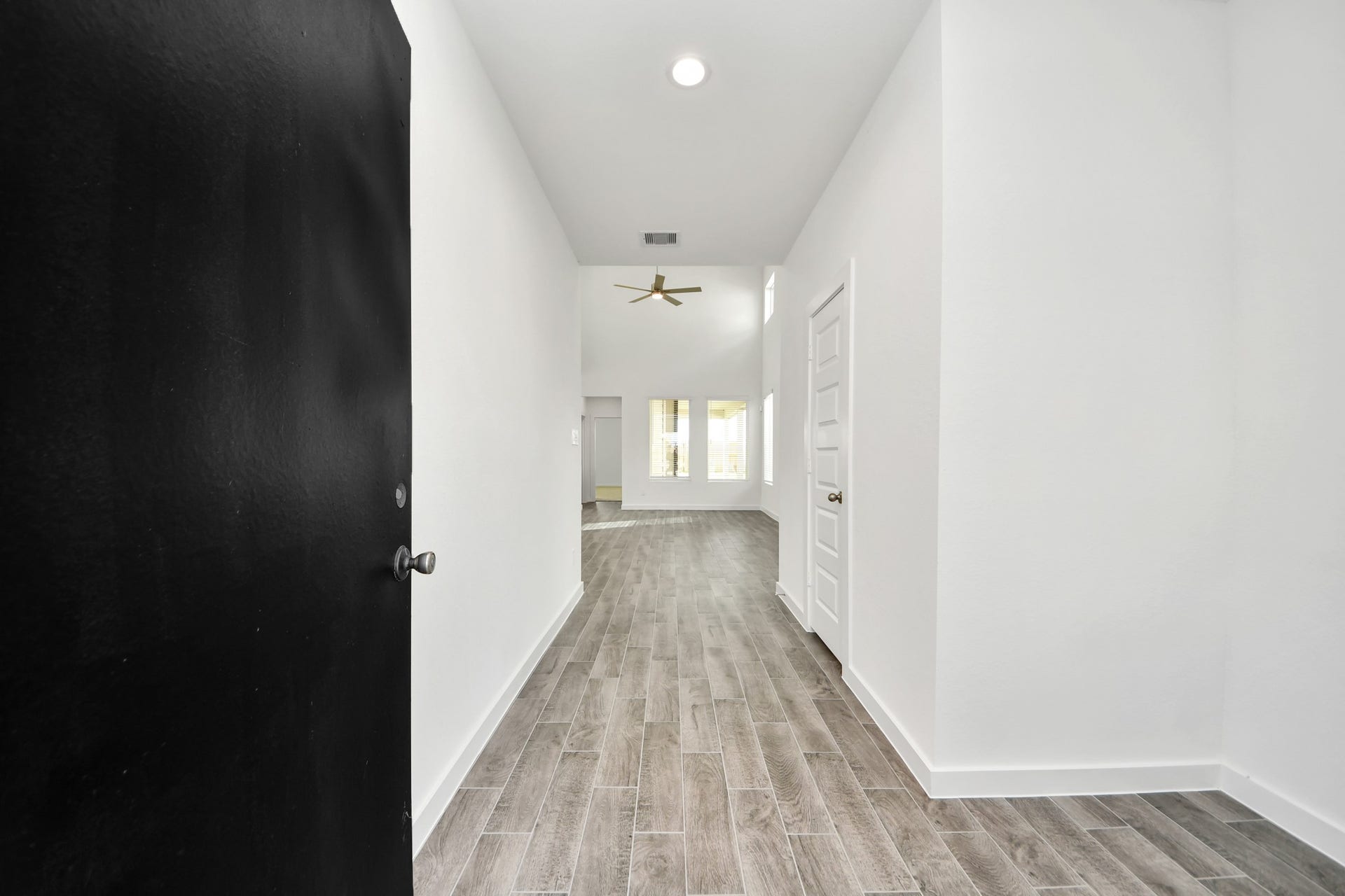 As you step into the threshold of this luxurious home, you'll soon be welcomed by an elegant glass door (to be installed). Inside, soaring ceilings amplify the spaciousness, while the refined wood-look tile flooring and oversized baseboards exude sophistication and charm. Sample photo of completed home with similar floor plan. Actual colors and selections may vary.