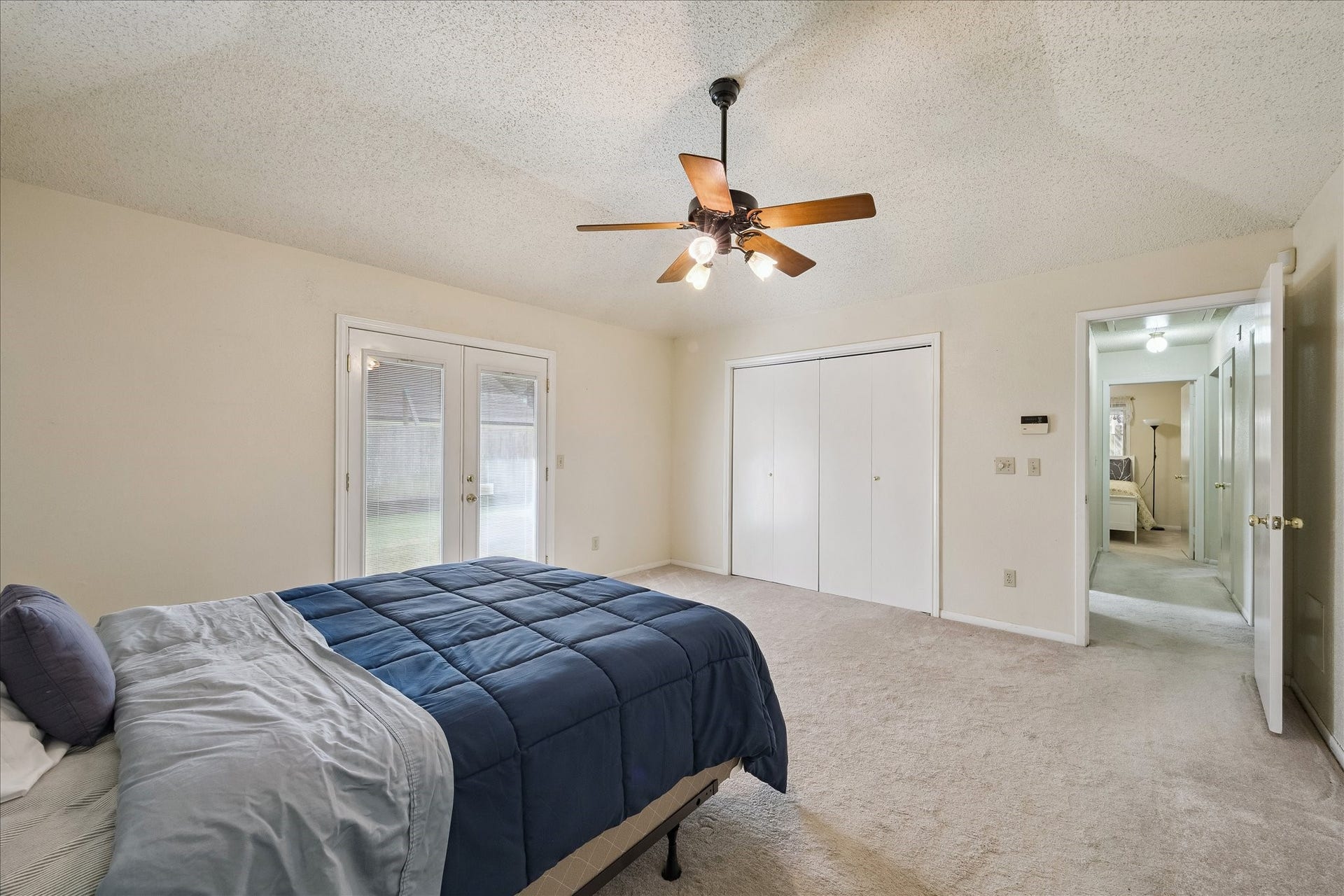 Primary Suite is separated from the other bedrooms by  a long hallway