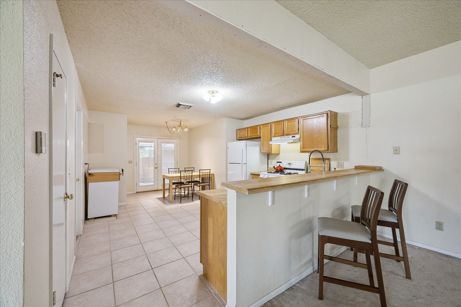 Large kitchen with breakfast bar and kitchen dining area.