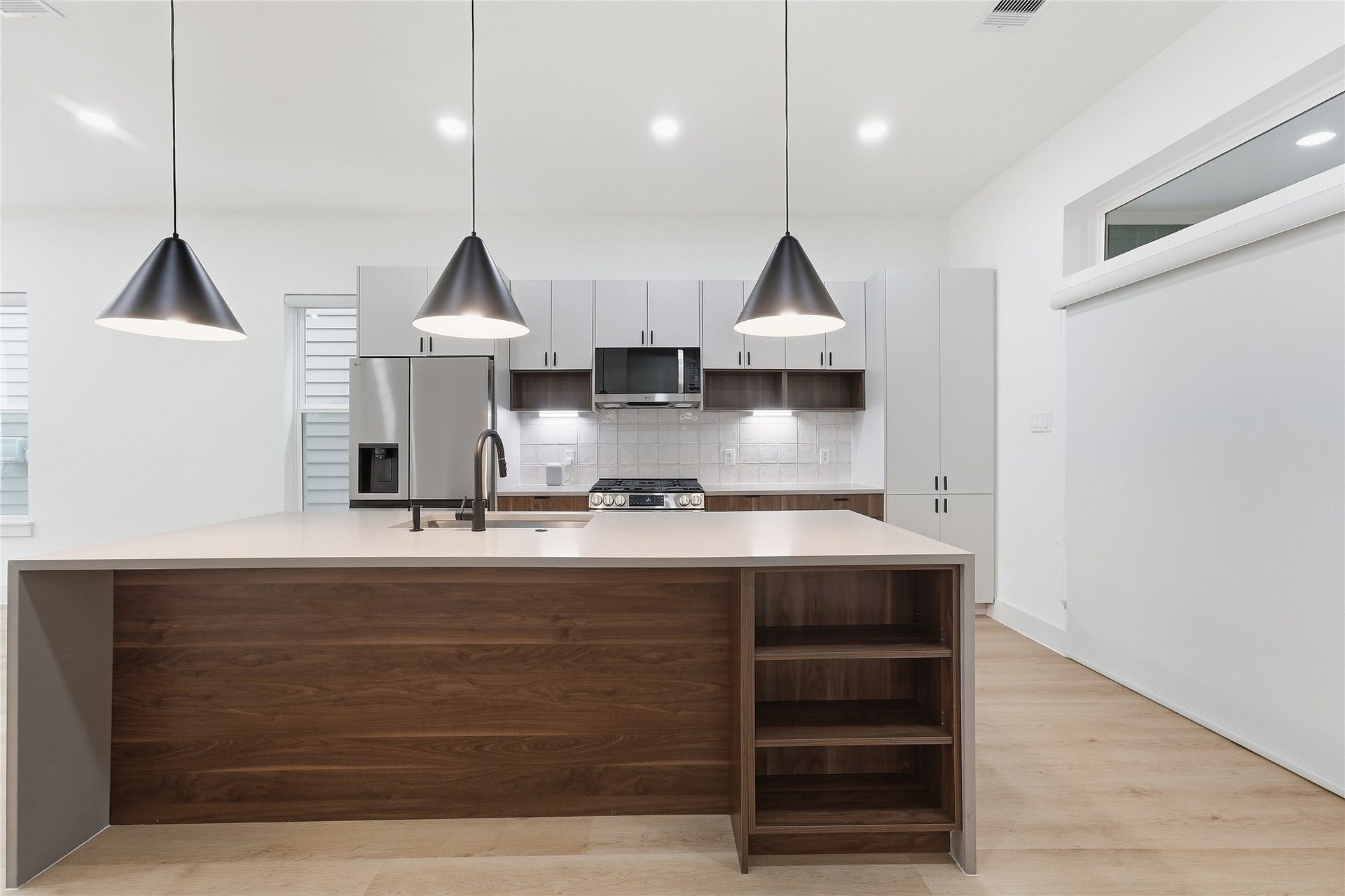 Kitchen with Oversized Waterfall Quartz Island