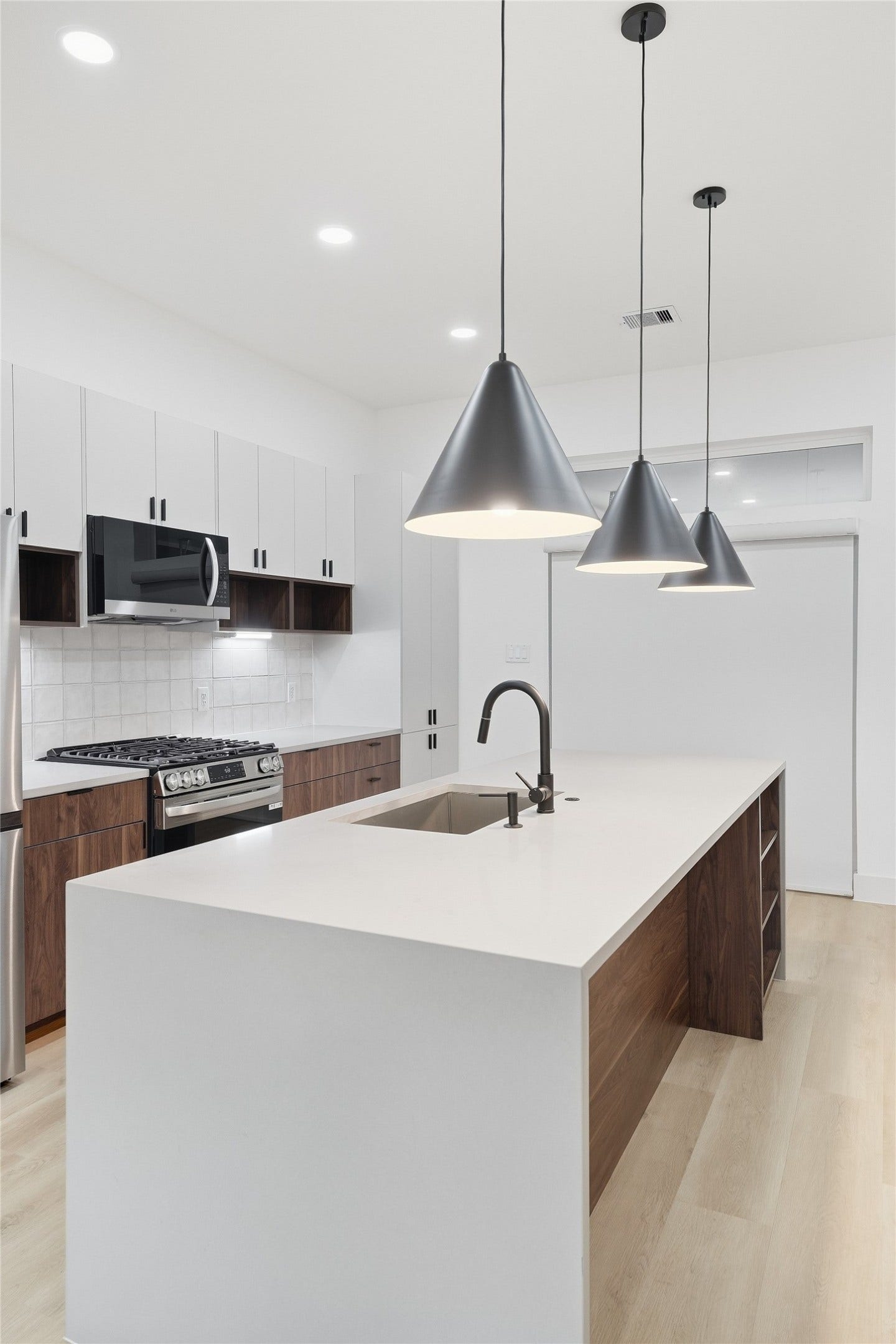 Kitchen with Oversized Waterfall Quartz Island