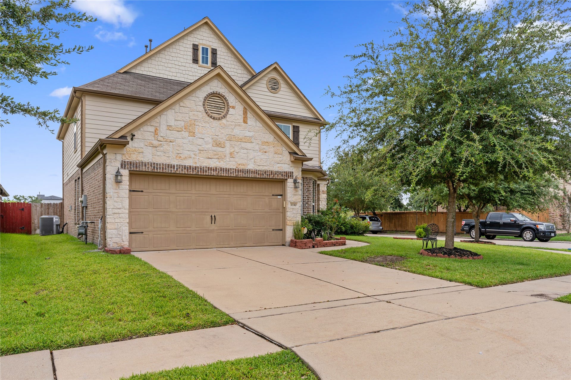3330 Cabin Wood Way, Houston, TX 77084 Long driveway and front of home showing off its elegant stone front.
