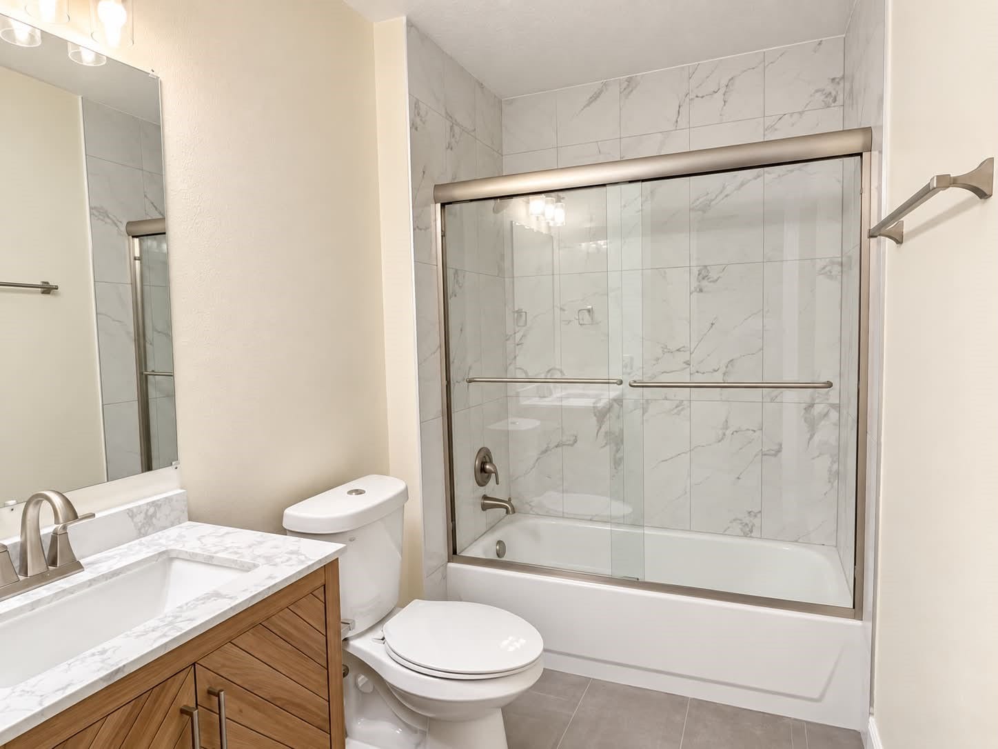 18131 Eganville Circle, Tomball, TX 77377 Full secondary bath with tub and shower enclosed with a sliding glass door