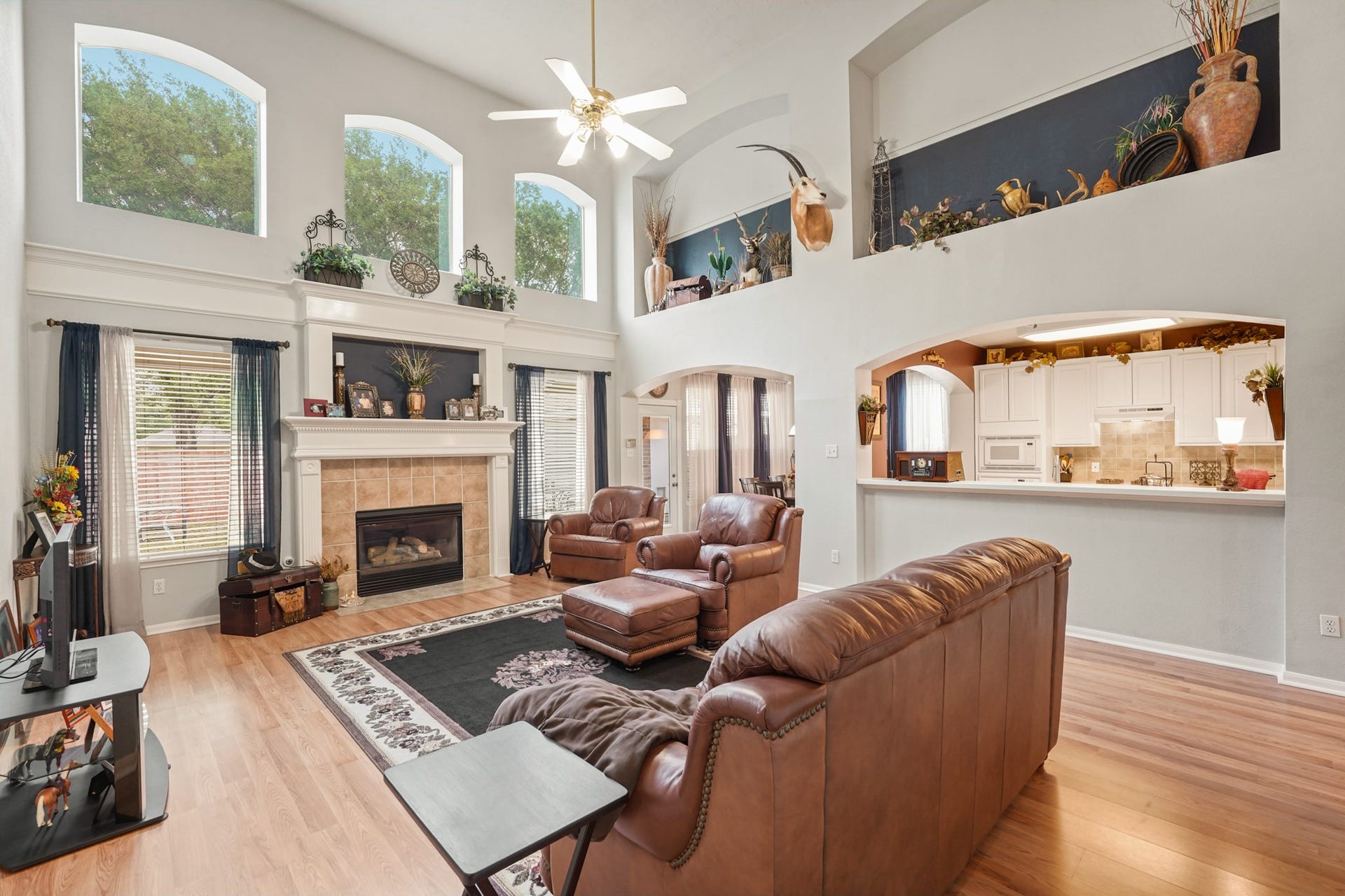 Another view of sizable Family Room, fireplace and breakfast bar seating.