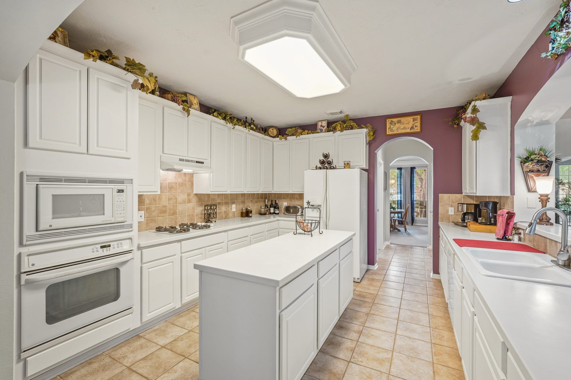 Electric Oven, Dishwasher. Tile backsplash and flooring.