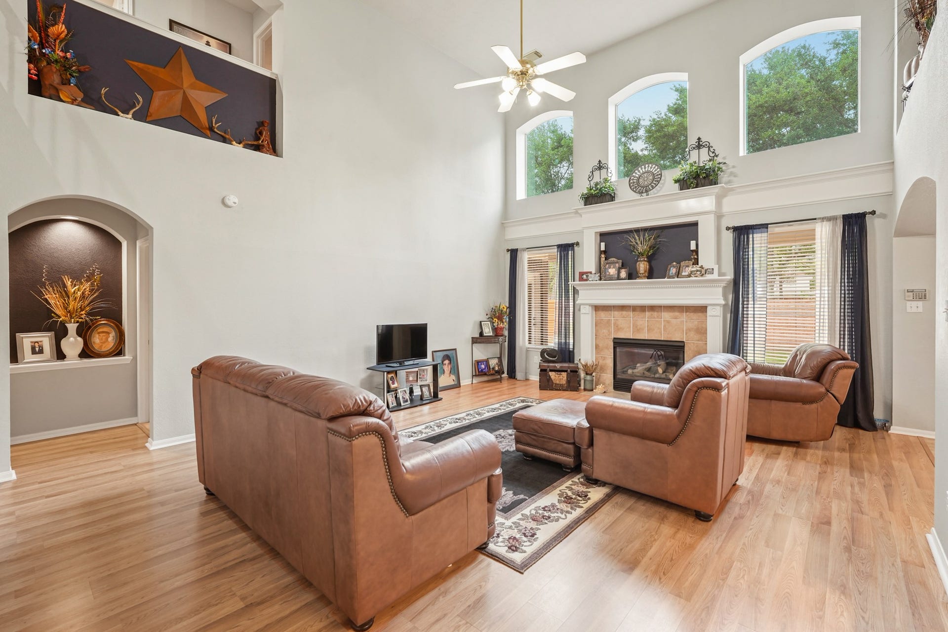 View of the Living Room with three transom windows and art niche with high ceiling.