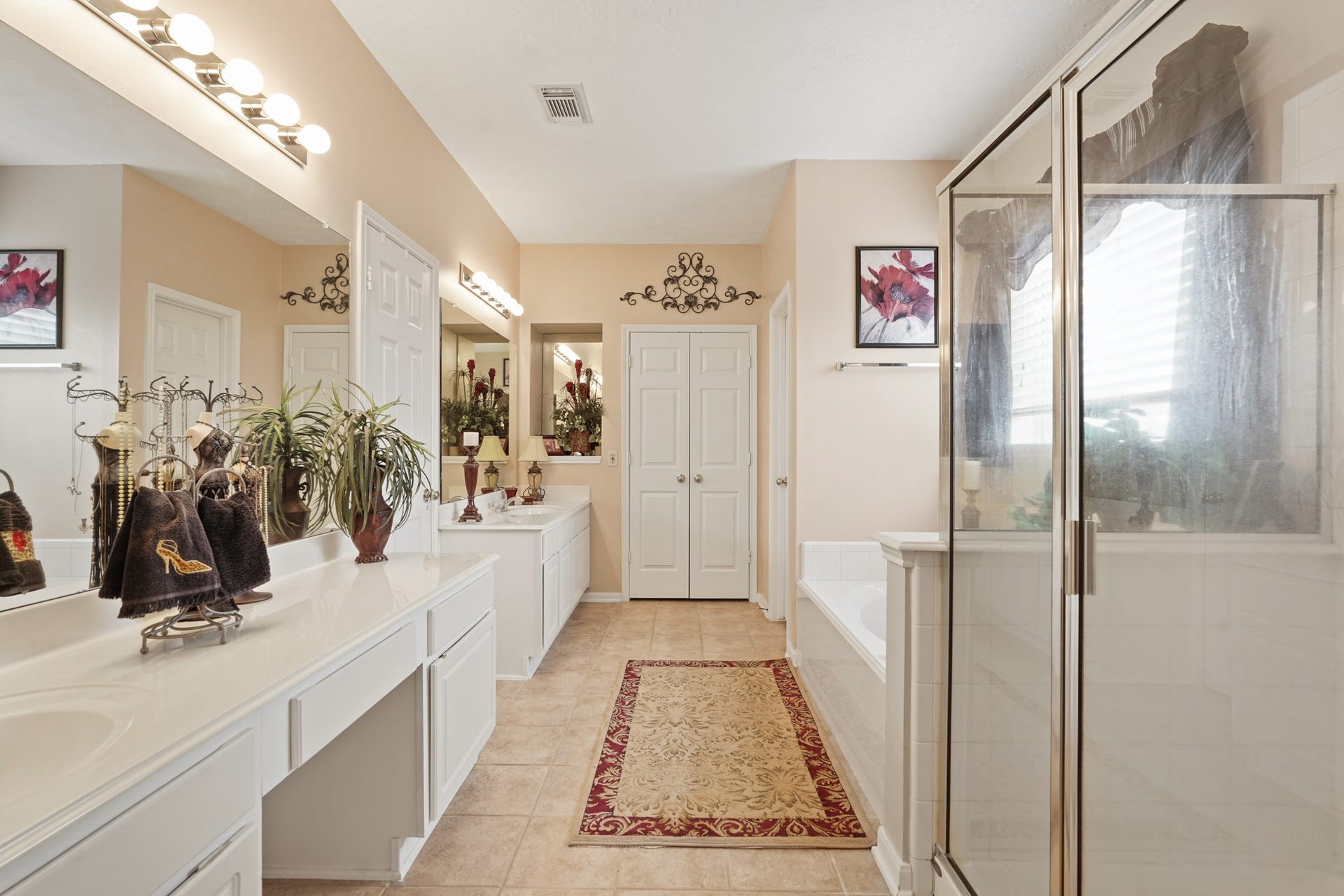 Primary Bathroom features dual sinks, separate shower, soak tub, and separate linen and large walk-in closet.