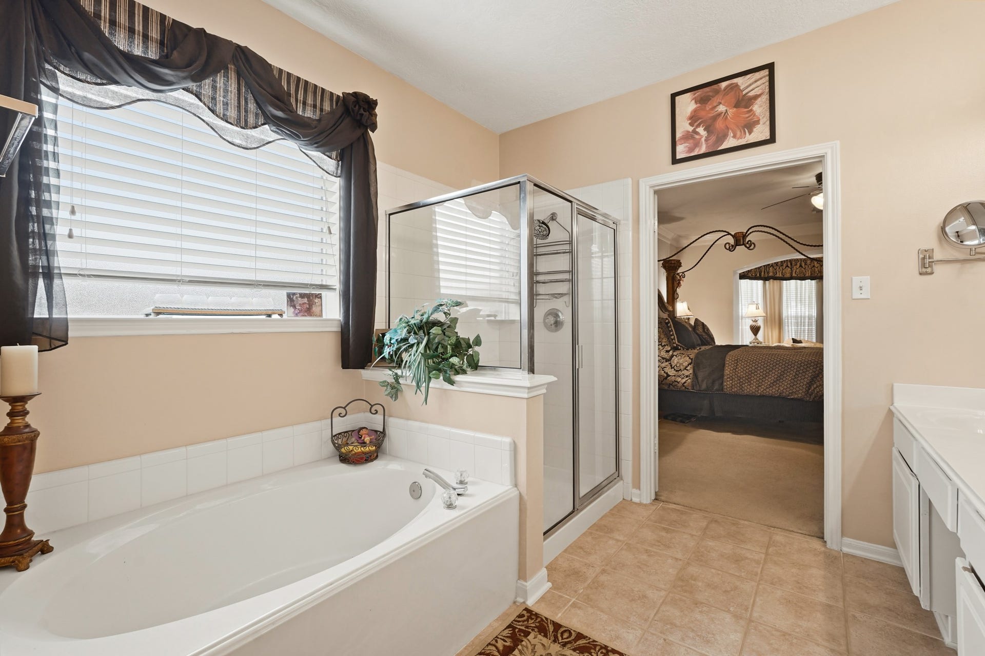 The Primary Bath Soak Tub and Separate glass enclosed framed shower.