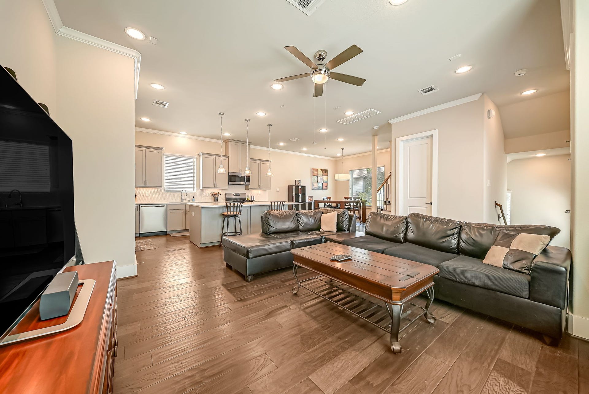 5916 Petty Street, #A, Houston, TX 77007 Bright living area with engineered hardwood flooring, crown molding, and generous natural light throughout.