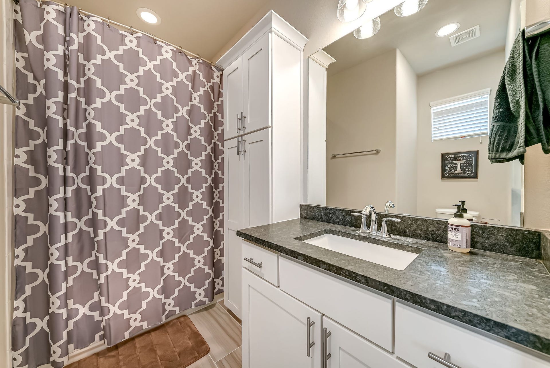 5916 Petty Street, #A, Houston, TX 77007 Secondary bathroom with quality finishes, generous storage, and stylish flooring.