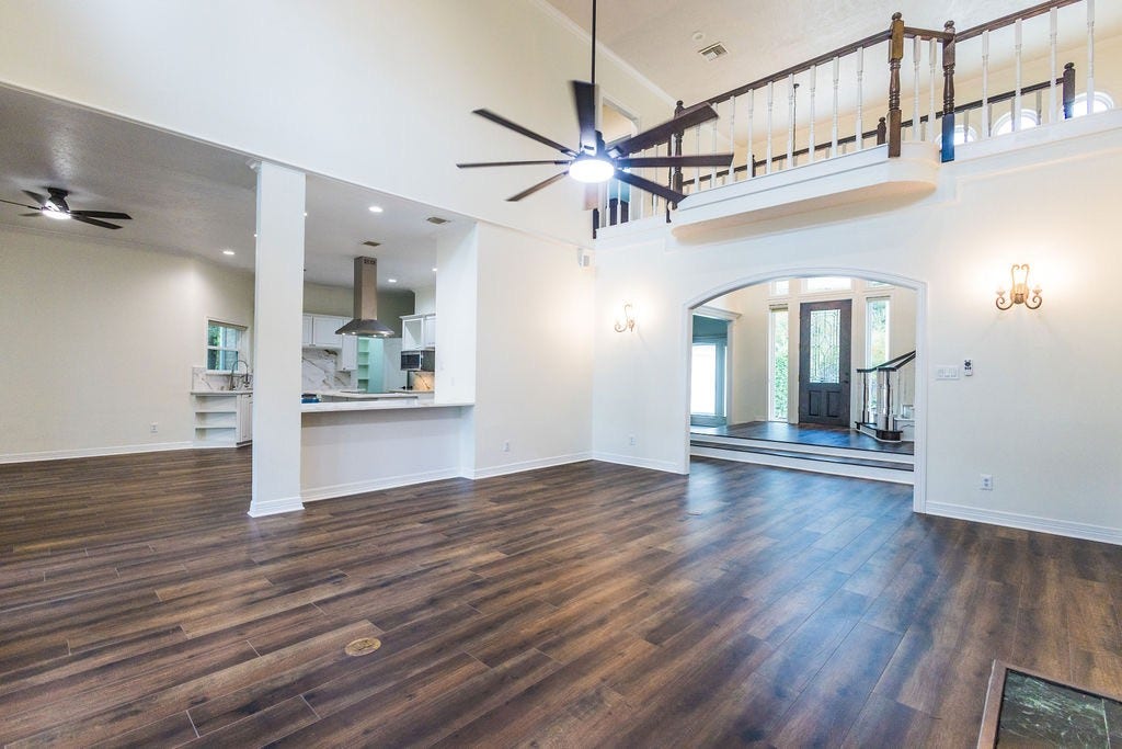 3230 Lake Island Drive, Montgomery, TX 77356 Living room has two story high ceilings making it feel light and airy