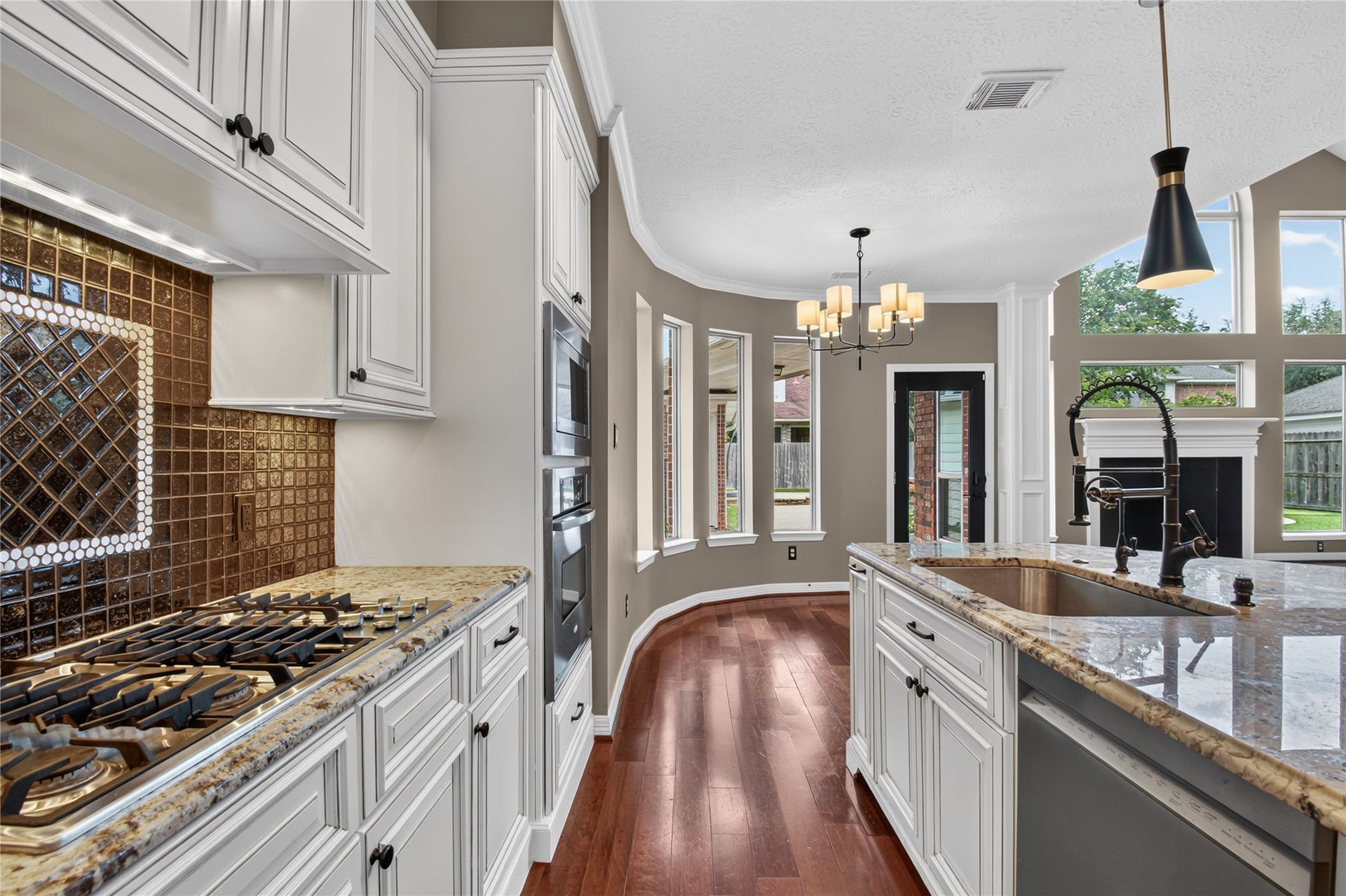 Gas cooktop, abundant cabinetry and granite counters provide plenty of workspace for cooking and entertaining.