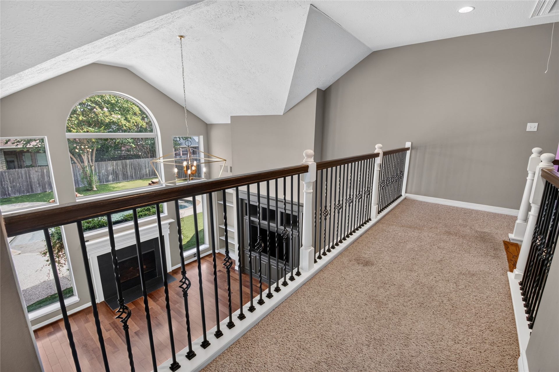 Upstairs overlook showcases the dramatic two-story family room and the homes open, light-filled design.