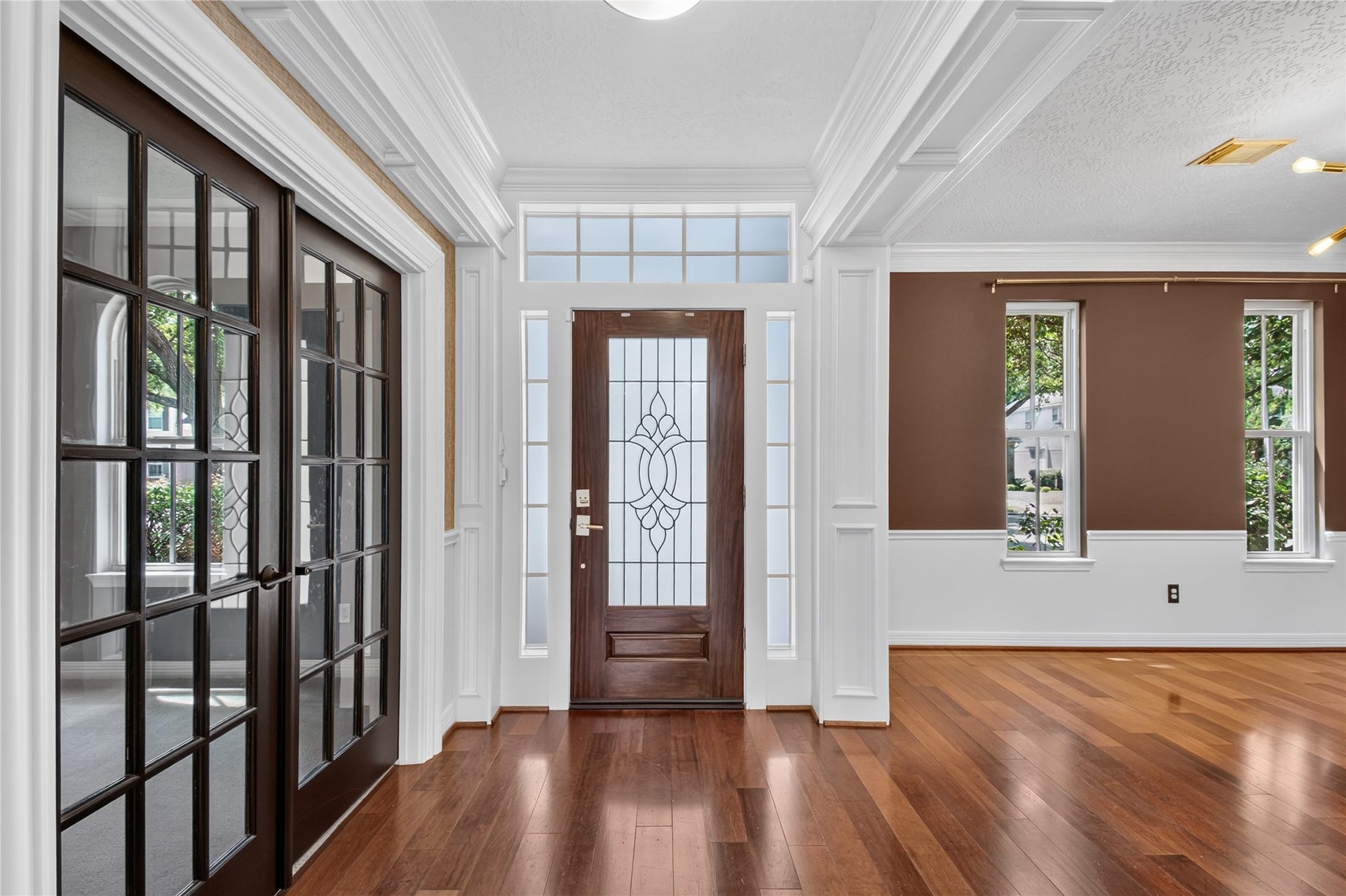 Welcoming foyer is flanked by the private study and formal dining room, with REAL WOOD FLOORS adding warmth and character.