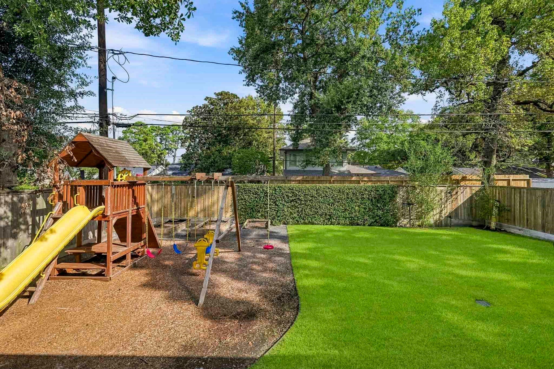 private outdoor playground with garden planters that include a self-watering system