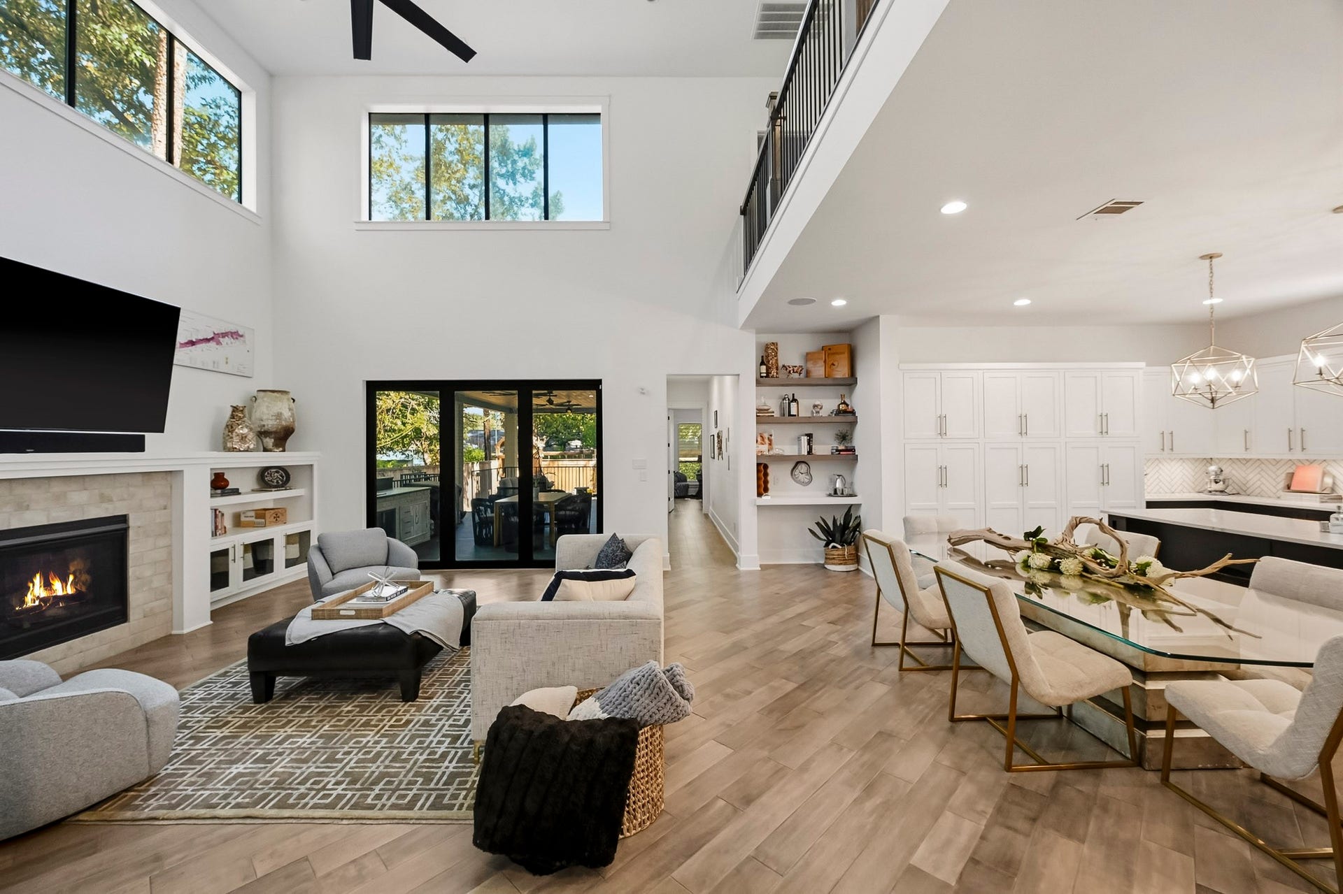 Exquisite great features glass front cabinetry, shelving and a cozy fireplace with a fold open glass door to the outside deck.