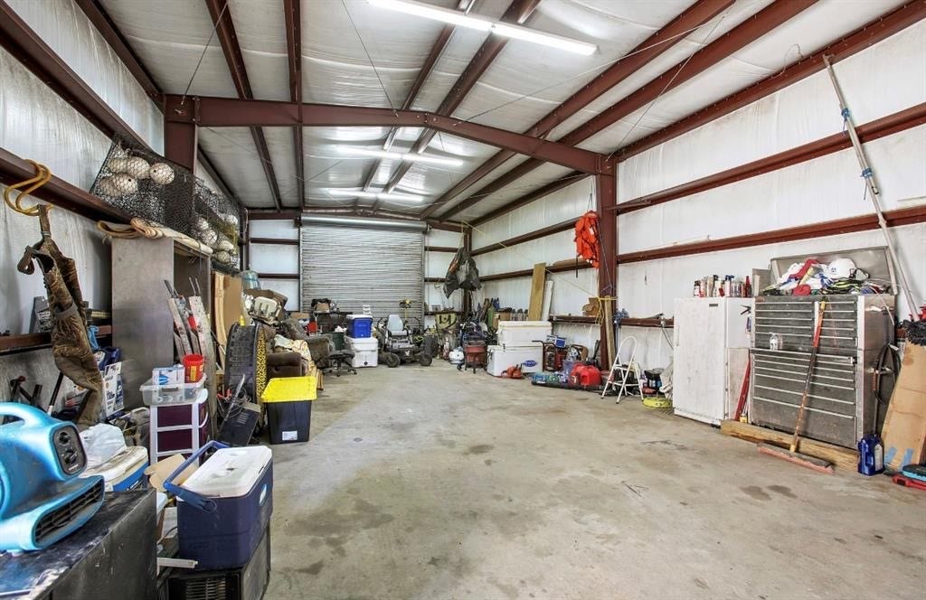 15602 Fir Road, Santa Fe, TX 77517 Interior photo of shop shows expansive workspace, lighting and insulation.