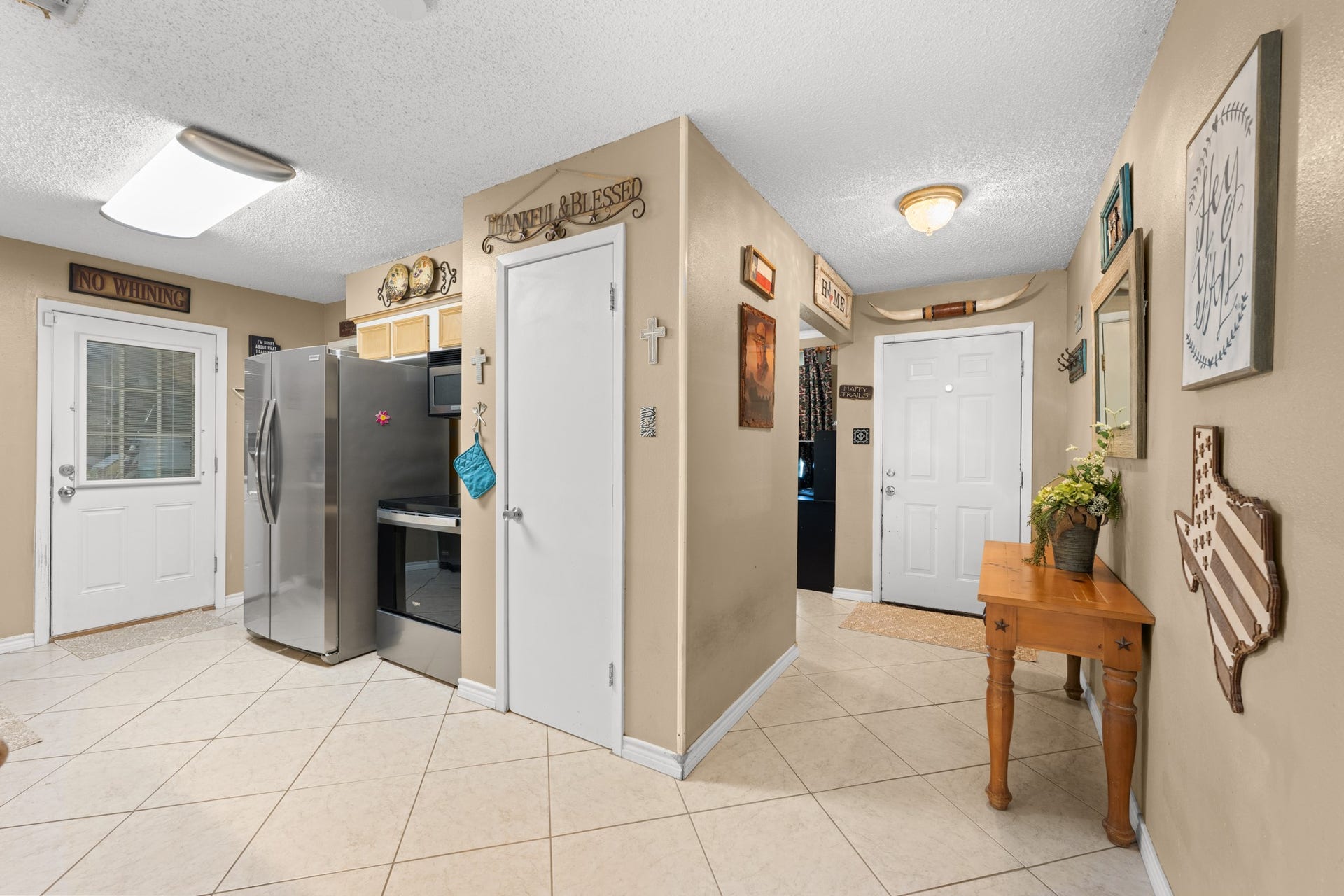 15602 Fir Road, Santa Fe, TX 77517 Functional layout with easy access between the kitchen, entryway, and main living areas, creating a seamless everyday flow. Stainless steel appliances, ample storage, and tile flooring add both style and practicality to the space.