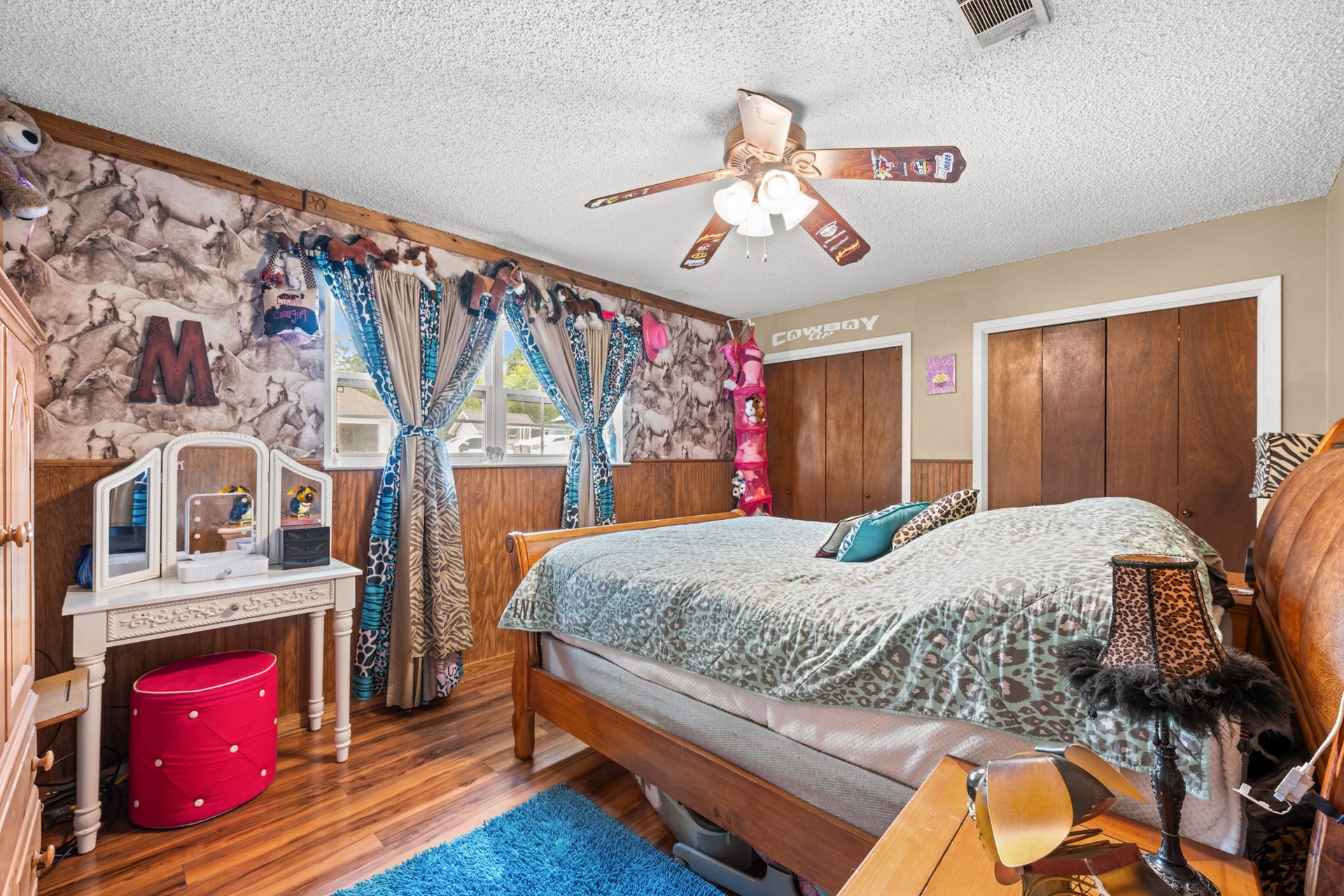 15602 Fir Road, Santa Fe, TX 77517 Spacious secondary bedroom featuring wood-look flooring, ample closet storage, and large windows for natural light. Unique design touches and a flexible layout make this space ideal for a bedroom, guest room, or hobby area.