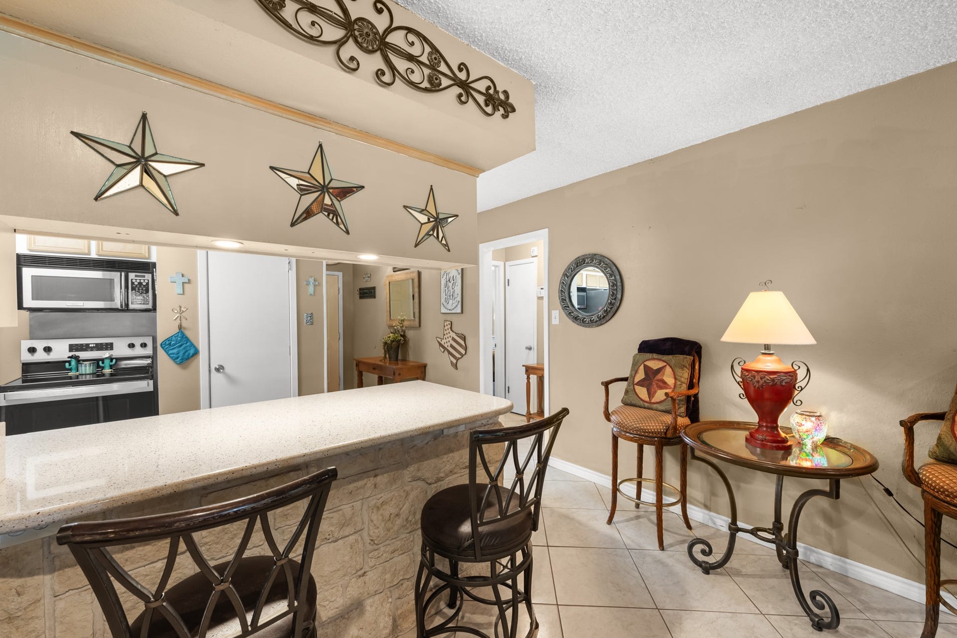 15602 Fir Road, Santa Fe, TX 77517 Oversized breakfast bar with stone detailing and seating creates the perfect space for casual dining or gathering with guests. The open-concept design provides a seamless connection between the kitchen and main living areas for easy everyday living.