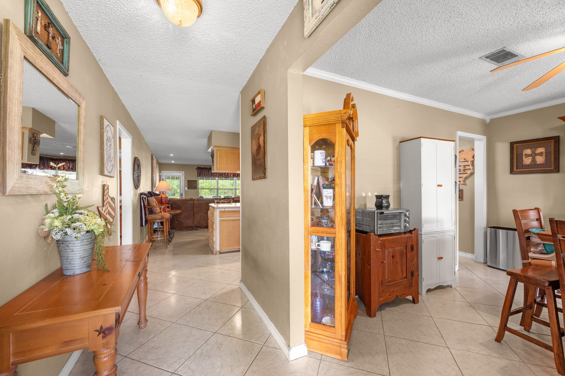 15602 Fir Road, Santa Fe, TX 77517 Welcoming entryway with durable tile flooring and an open flow into the dining and living spaces. Neutral tones and abundant natural light create a warm, inviting atmosphere throughout the home.
