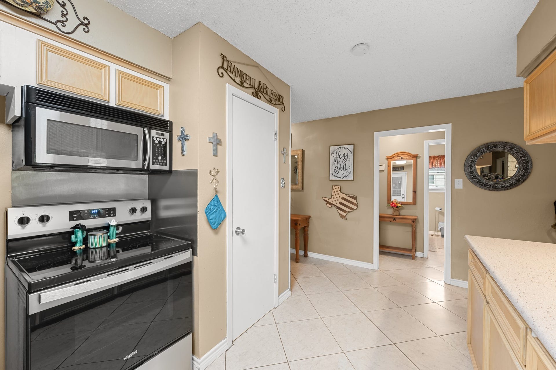 15602 Fir Road, Santa Fe, TX 77517 Functional kitchen layout featuring stainless steel appliances, extensive cabinetry, and generous counter space for meal prep and storage. The open design and easy access to adjacent living areas create a seamless flow throughout the home.