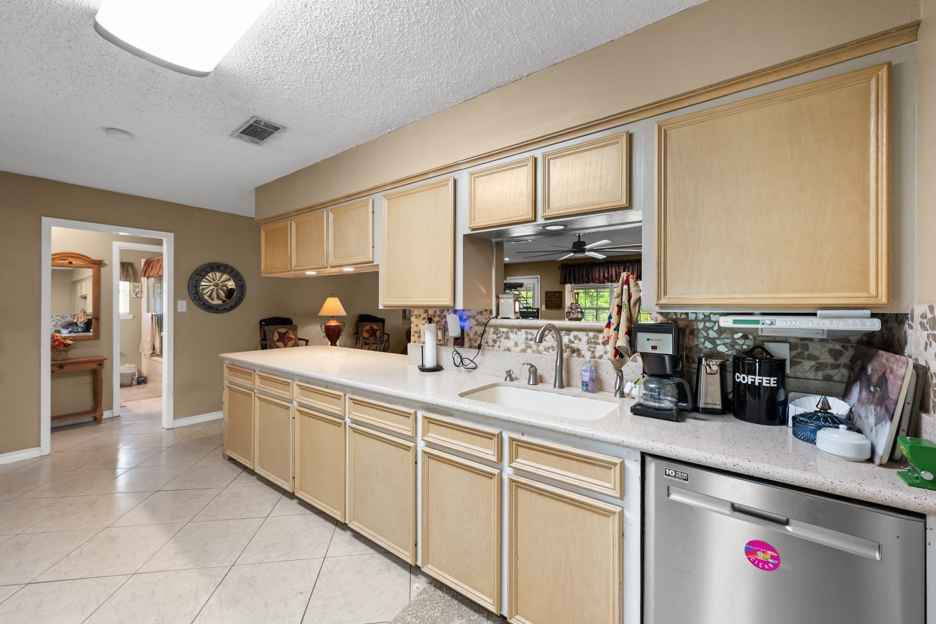 15602 Fir Road, Santa Fe, TX 77517 Spacious kitchen featuring extensive cabinetry, generous prep space, and a large peninsula overlooking the main living area. Stainless steel appliances, tile flooring, and an open layout provide both functionality and everyday convenience.