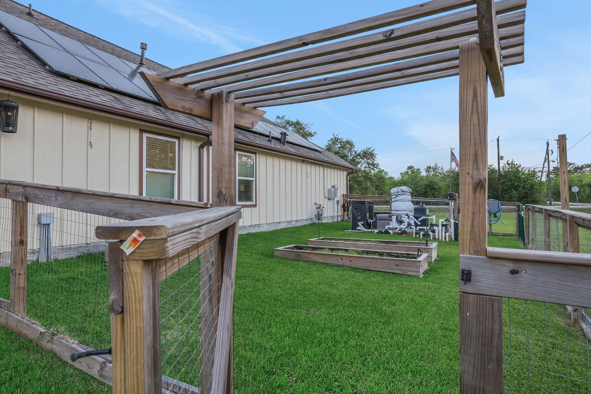 12751 County Road 283, Alvin, TX 77511 Charming fenced area features a wooden entry to a well-maintained green space for your home garden.