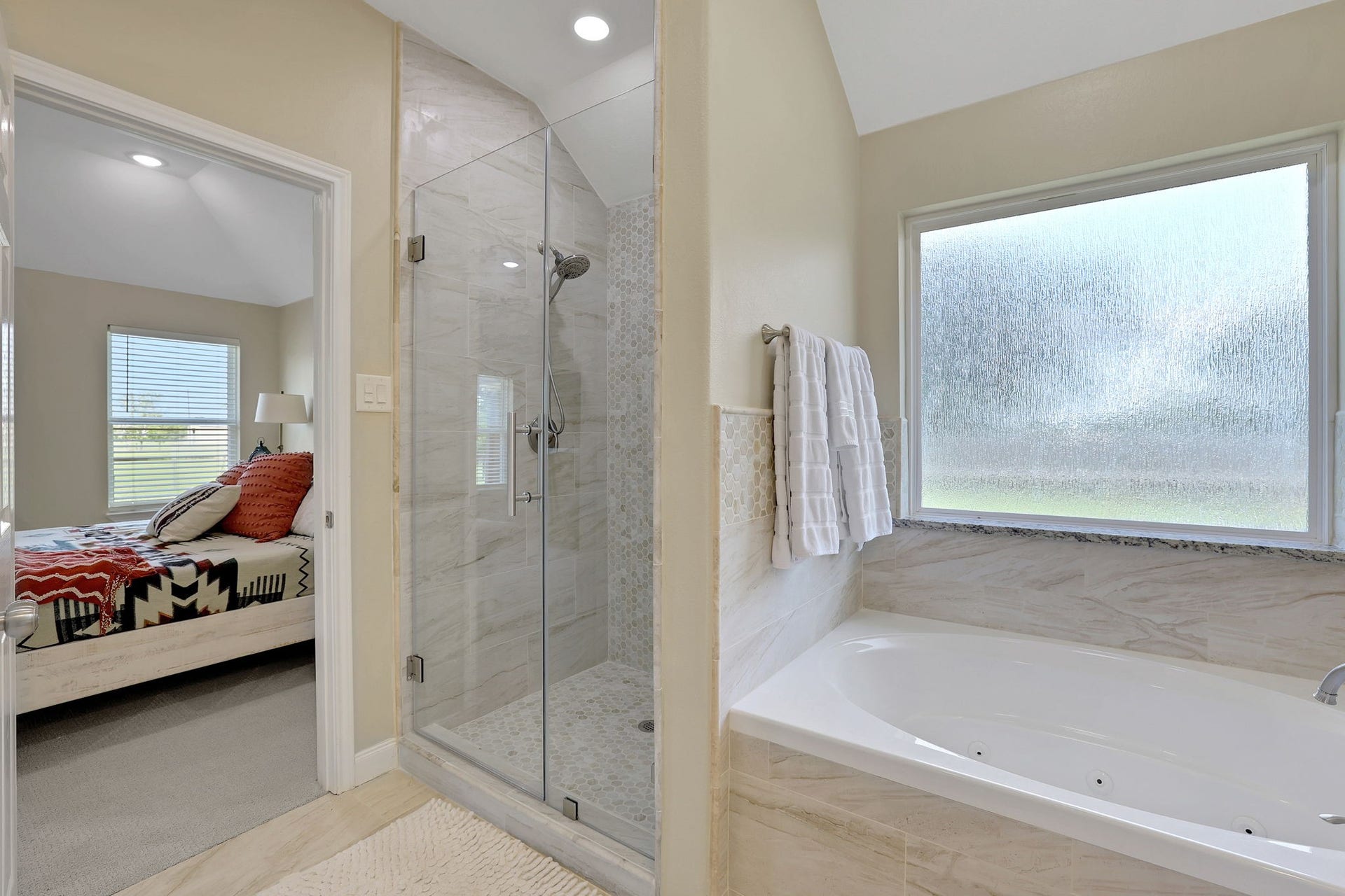 12751 County Road 283, Alvin, TX 77511 Freshly updated primary bath with a new tile surround that feels like a true spa retreat