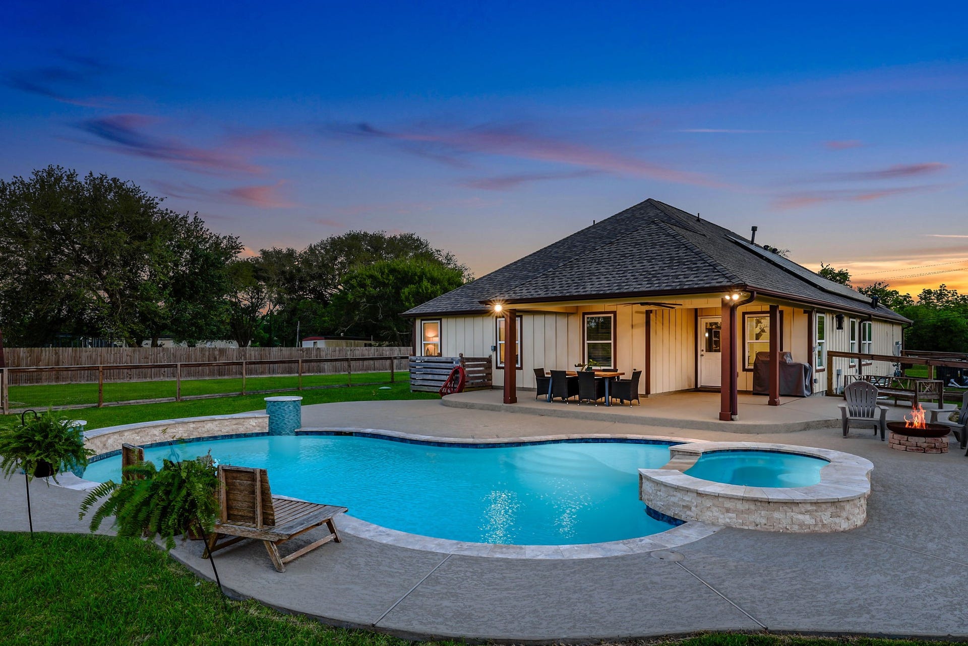 12751 County Road 283, Alvin, TX 77511 Experience the ultimate outdoor oasis with an oversized covered patio, sparkling pool, and inviting hot tub, perfect for relaxation and entertaining.