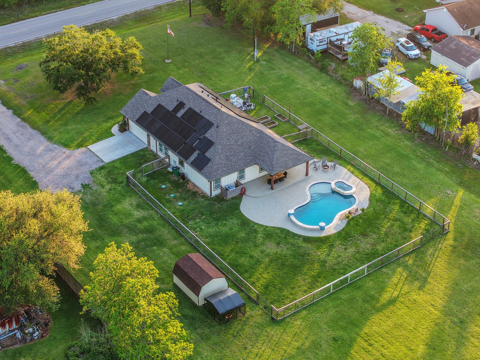 12751 County Road 283, Alvin, TX 77511 Spacious single-story home with solar panels, a beautifully landscaped yard, and a stunning pool with a spa.