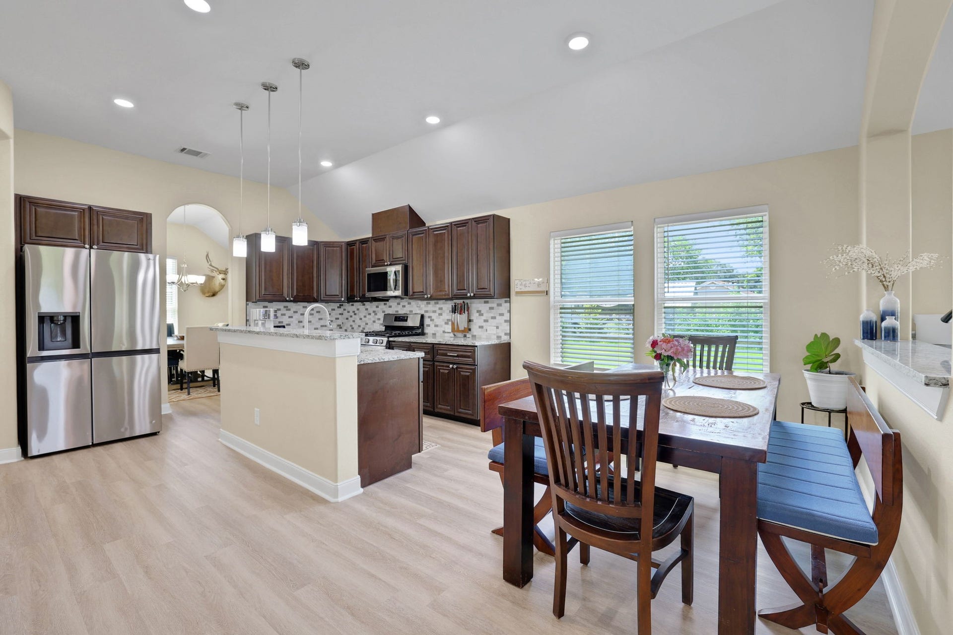 12751 County Road 283, Alvin, TX 77511 The half wall between the breakfast and family room defines the space well