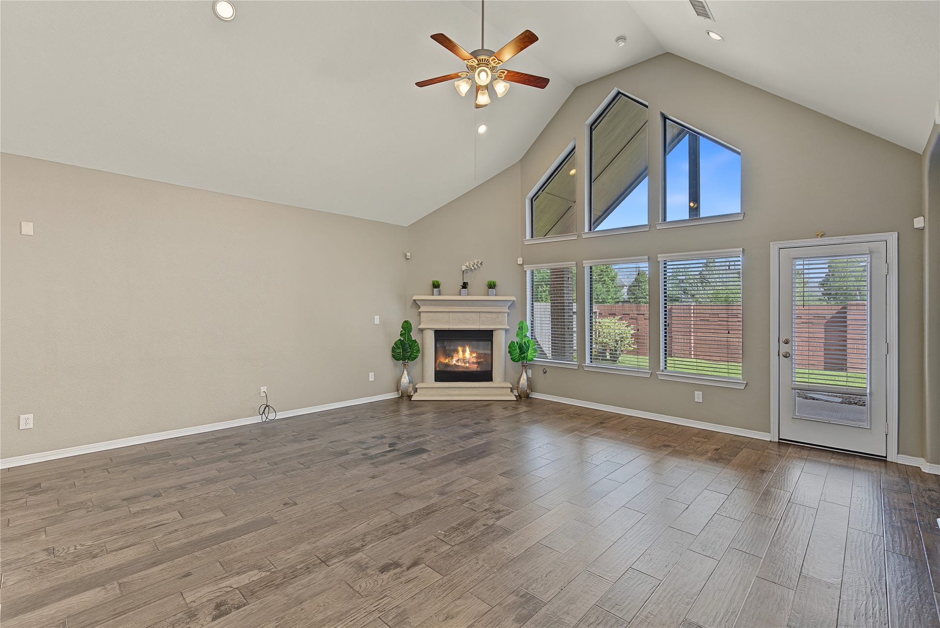 6723 Sotoria Lane, Sugar Land, TX 77479 a spacious great room with a cast stone fireplace